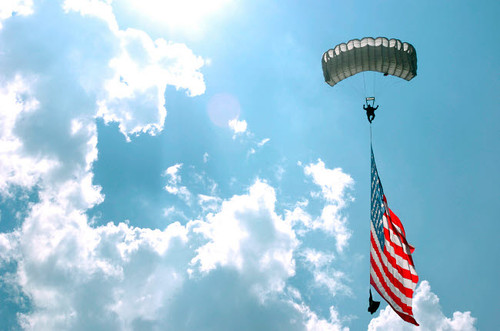 A skydiver carries a US flag while descending through the sky Poster Print by Stocktrek Images - Item # VARPSTSTK105666M A skydiver carries a US flag while descending through the sky Poster Print by Stocktrek Images - Item # VARPSTSTK105666M