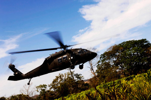 A US Army UH-60 Black Hawk helicopter flies out of an emergency landing zone Poster Print by Stocktrek Images - Item # VARPSTSTK102334M