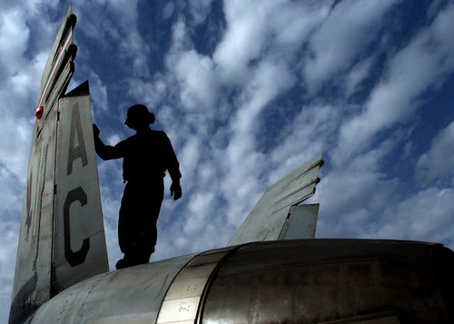 A Marine performs maintenance on an F/A-18A+ Hornet Poster Print by Stocktrek Images - Item # VARPSTSTK100812M
