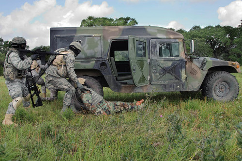 Soldiers recover the victim of a simulated roadside bomb Poster Print by Stocktrek Images - Item # VARPSTSTK103755M