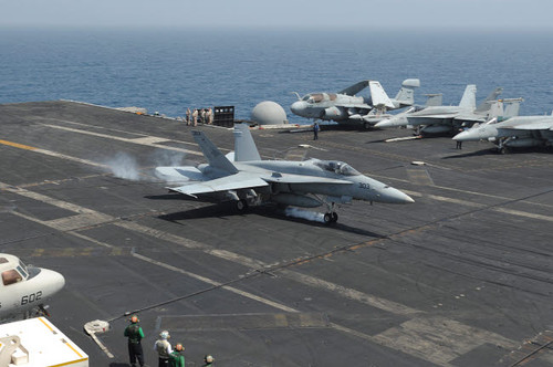 An F/A-18C Hornet lands on the flight deck of USS Nimitz Poster Print by Stocktrek Images - Item # VARPSTSTK107690M