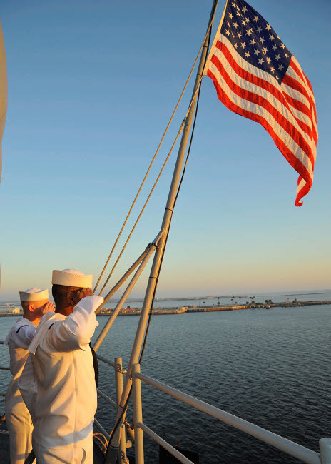 Sailors salute the national ensign aboard USS Bataan Poster Print by Stocktrek Images - Item # VARPSTSTK106681M
