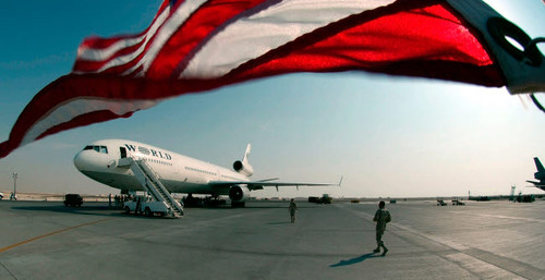 The wind blows the US flag over the top of the DC-10 rotator aircraft Poster Print by Stocktrek Images - Item # VARPSTSTK101068M