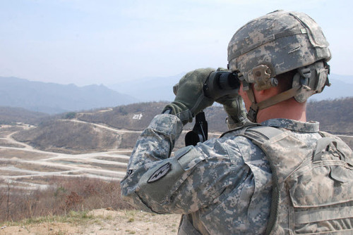 Soldier observes an adjust fire mission through binoculars Poster Print by Stocktrek Images - Item # VARPSTSTK105946M