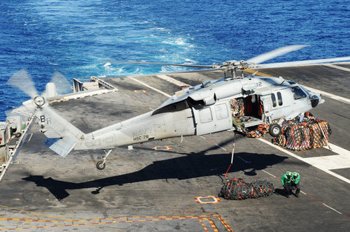 An MH-60S Sea Hawk helicopter conducts a vertical replenishment Poster Print by Stocktrek Images - Item # VARPSTSTK108169M