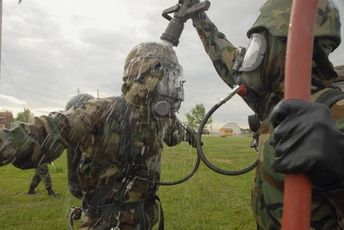 US Air Force Soldier decontaminates an Airman Poster Print by Stocktrek Images - Item # VARPSTSTK102539M