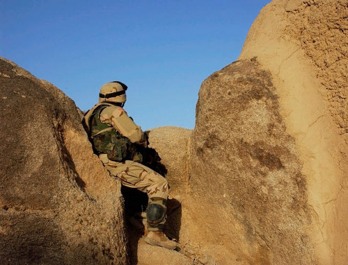 A soldier takes up a position during a security halt Poster Print by Stocktrek Images - Item # VARPSTSTK100627M