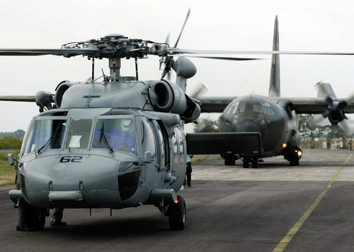 US Navy SH-60B Seahawk helicopter and an Australian C-130 Hercules prepare for takeoff Poster Print by Stocktrek Images - Item # VARPSTSTK103072M