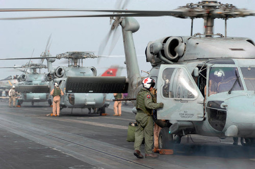 Helicopter crews change out on the flight deck aboard USS Theodore Roosevelt Poster Print by Stocktrek Images - Item # VARPSTSTK101201M