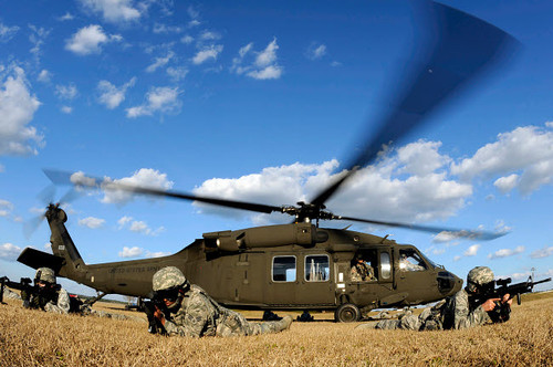 Airmen provide security in front of a UH-60 Black Hawk Poster Print by Stocktrek Images - Item # VARPSTSTK105654M
