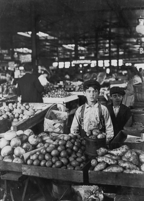 Two Boys operate a fruit stand packed full of Fruits & Vegetables in a market Poster Print - Item # VARBLL058754809L
