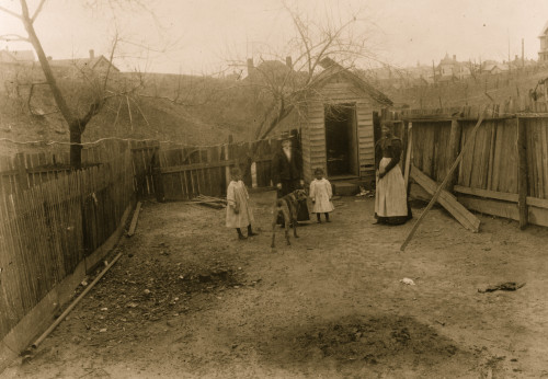 African American family standing in a yard in Georgia with dig and white visitor Poster Print - Item # VARBLL0587634413