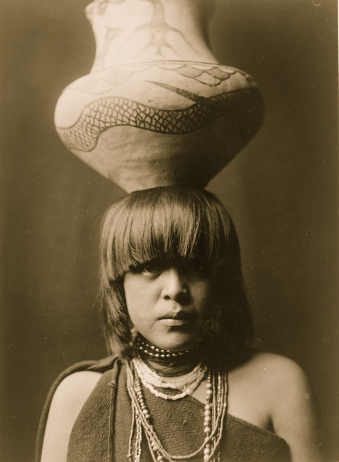 San Ildefonso girl, head-and-shoulders portrait, facing front, with large jar balanced on her head. Poster Print - Item # VARBLL058747686L