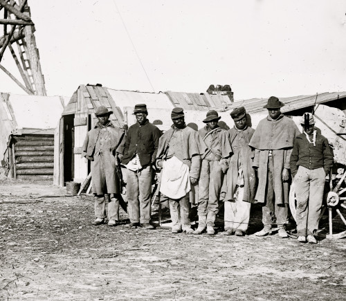 group of seven "contrabands" dressed in old Union uniforms standing in front of a wagon and shack. Poster Print - Item # VARBLL058753362L