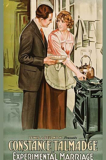 Woman stands over a stove; man in suit holds a bowl Poster Print - Item # VARBLL058762147L