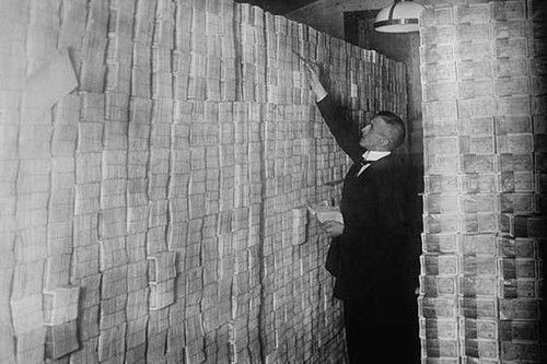 Inflation in Weimar Germany has paper money stacked from Floor to Ceiling in a Berlin Bank; banker is counting sheaves of bundled notes. Poster Print by unknown - Item # VARBLL058745859L