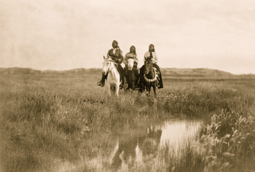 Three Sioux Indians on horseback facing front by pond on plains. Poster Print - Item # VARBLL058746999L