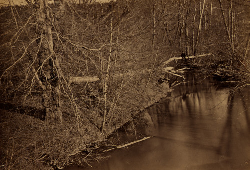 Two men sitting on and close by a fallen tree over Pope's Head Creek in Clifton, Virginia near a destroyed railroad bridge on the Orange and Alexandria Railroad Poster Print - Item # VARBLL058745406L