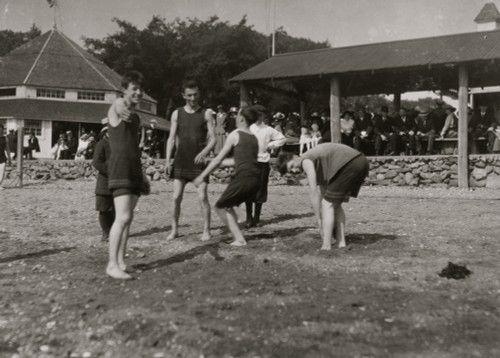 Teenage Boys sport on a sandy Beach, A pavilion of adults in the rear Poster Print - Item # VARBLL058754327L