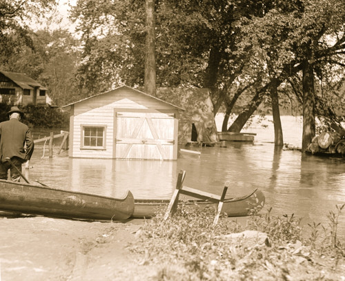 River overflows into garage; canoes set on the banks Poster Print - Item # VARBLL058750148L