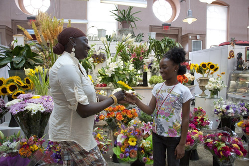 African American Mother gives child a flower in flower store Poster Print - Item # VARBLL058759423L