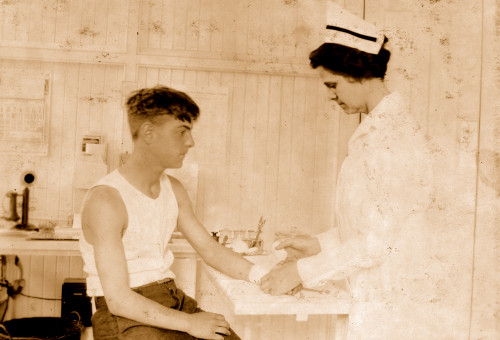 Nurse at Cheney Silk Mills bandages a boy's arm Poster Print - Item # VARBLL058754231L