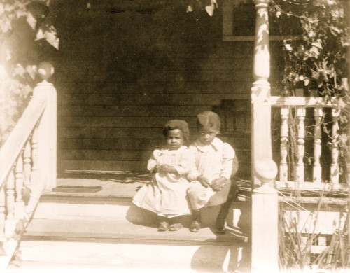 Two African American children sitting on steps to porch Poster Print - Item # VARBLL0587635339