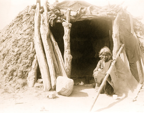 Old Navajo Indian seated in doorway of hogan Poster Print