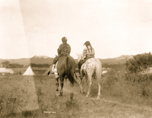 Two daughters of a chief on horseback, riding away from camera toward tents in background Poster Print - Item # VARBLL058747000L
