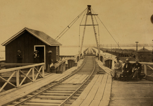 Railroad bridge across the Potomac River. Three men are seated at right: S. Seymour, chief engineer, C.B. Morse, constructing engineer, S.S. Post & Co., contractors. Poster Print - Item # VARBLL058745592L