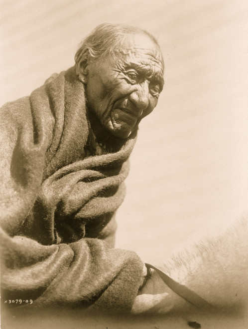 Elderly Piegan man, half-length portrait, wrapped in blanket, seated on horse, facing front. Poster Print - Item # VARBLL058747679L