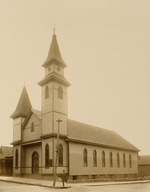 African American man standing on sidewalk in front of church Poster Print - Item # VARBLL0587632461
