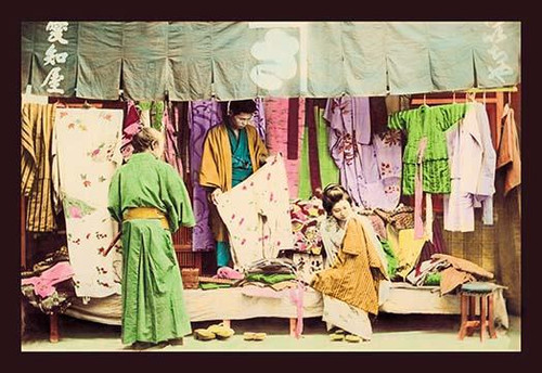 Grocery and Fruit Shop.  This image is from a collection of hand tinted Meiji era photographs from Japan that were published and bound in a rice paper book in multiple volumes. Poster Print by Imperial Art School of Japan - Item # VARBLL0587022302