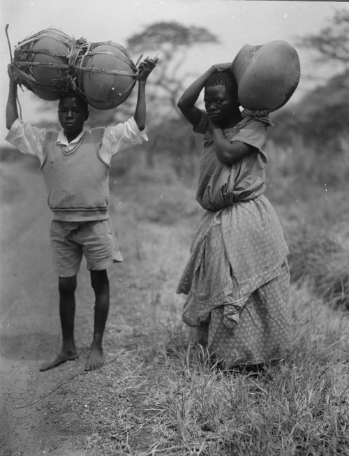 Uganda boy and girl carrying jars Poster Print - Item # VARBLL058746539L