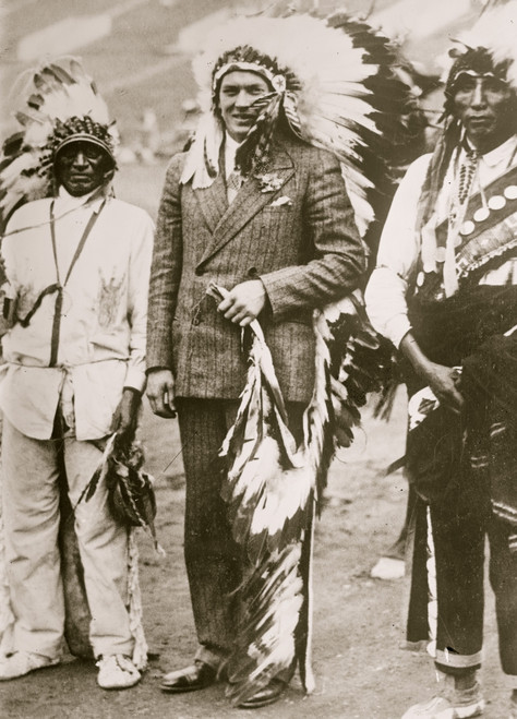 Gene Tunney with native Americans; Tunney wears headdress Poster Print - Item # VARBLL058751400L