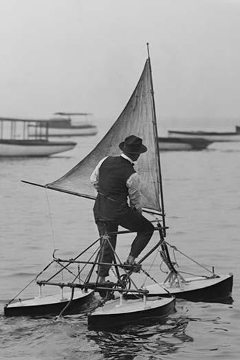 Man Experiments with his water tricycle contraption driven by wind and sails Poster Print by unknown
