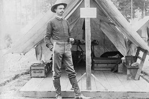 African American soldier T.R. Clarke, full-length portrait, wearing hat and uniform, standing in front of tent, facing right, during the Spanish-American War. Poster Print - Item # VARBLL0587244658