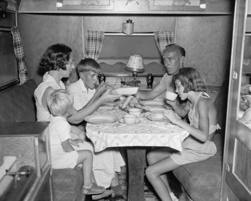 American Family Dining At The Table In Their Trailer Camper. June 4 History - Item # VAREVCHISL040EC447