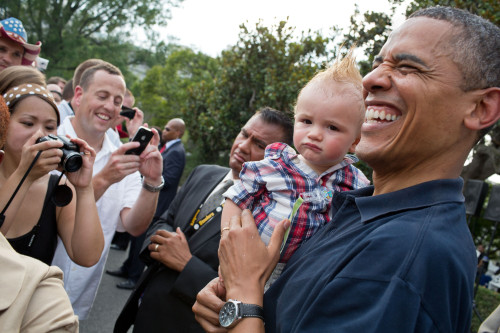 President Barack Obama Holds A Baby During An White House Independence Day Celebration. July 4 History - Item # VAREVCHISL040EC159