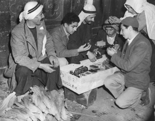 Arab Palestinians Examine Weapons In A Jerusalem Market. Guns History - Item # VAREVCHISL038EC761