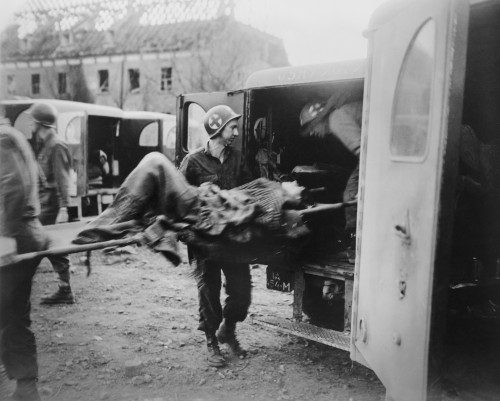 American Medics Place An Almost-Dead German Slave Laborer In An Ambulance At Nordhausen. U.S. 3Rd Army Liberated The Camp On April 12 History - Item # VAREVCHISL037EC321