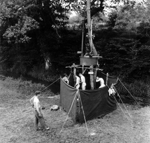 U.S. Soldiers Showering In An Installation Mounted Along A Hedgerow In Normandy. June-July 1944. Normandy Campaign History - Item # VAREVCHISL037EC243