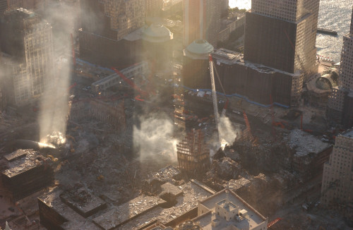 Aerial View Of Ground Zero From The Northeast As The Late Afternoon Sun Illuminates The Smoke. Oct. 8 History - Item # VAREVCHISL039EC859