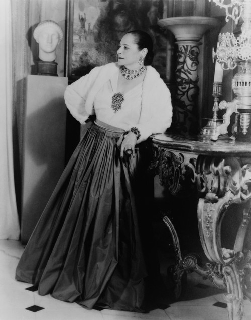 Helena Rubinstein 1870-1965 Polish Born Cosmetics Entrepreneur Wearing Dramatic Jewelry In The Dining Room Of Her New York City Apartment Ca. 1940. History - Item # VAREVCHISL024EC036