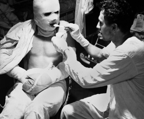 U.S. Sailor Dressed In Pressure Bandages After Suffering Burns During A Kamikaze Attack. He Is Being Fed Aboard The Hospital Ship History - Item # VAREVCHISL036EC962