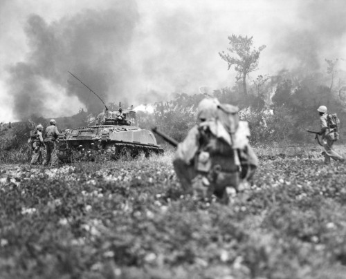 Marine Riflemen Moving Up Behind Flame-Throwing Tank On Okinawa. Ca. May 1945. World War 2. History - Item # VAREVCHISL036EC681