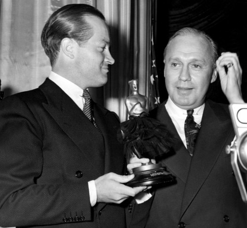 Bob Hope Presents Pal Jack Benny With A Gag Drag Oscar For His Performance In 1941'S Charley'S Aunt History - Item # VAREVCPBDBOHOEC150