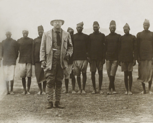 Theodore Roosevelt Standing In Front Of African Men Working For His Safari. They Served As Porters History - Item # VAREVCHISL045EC174