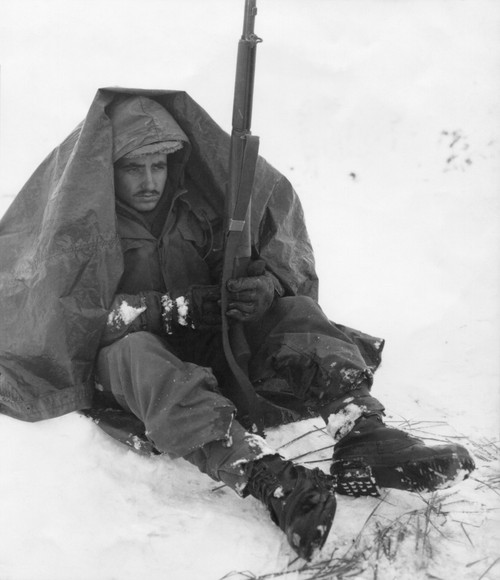 Soldier Of The U.S. 19Th Infantry Regiment Uses His Poncho To Get Protection From The Biting Wind And Cold. Yoju Area Jan. 10 History - Item # VAREVCHISL038EC313