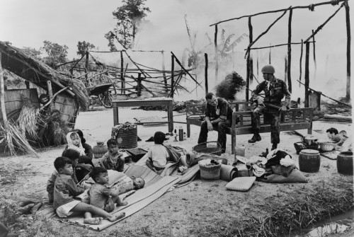 South Vietnamese Woman And Children Sit Amid Ruins Of Their Village History - Item # VAREVCHISL006EC112